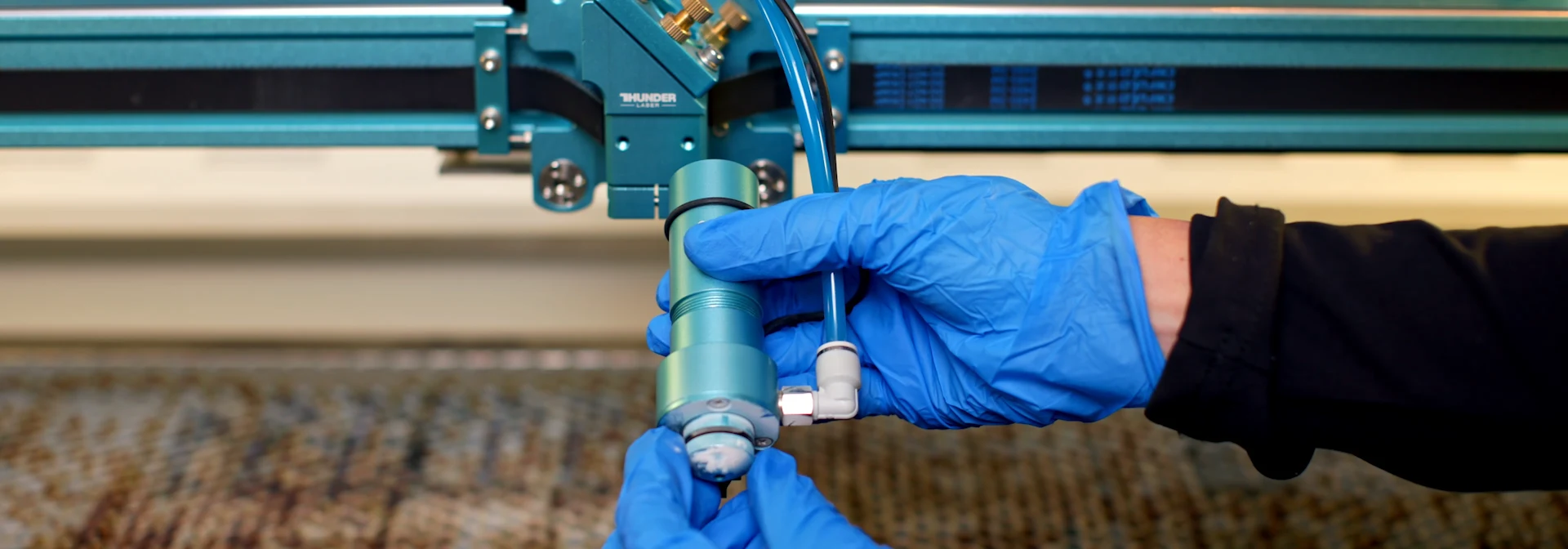 removing the laser nozzle assembly for focus lens inspection and cleaning