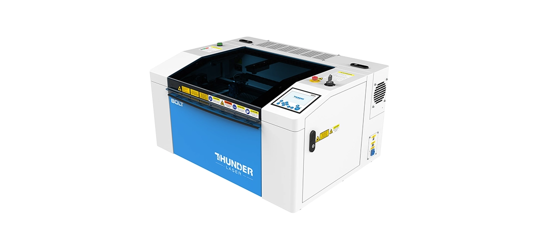 Thunder Bolt Product shot: Thunder Bolt CO2 laser cutting machine for acrylic and engraving — MaxLaser South Africa Action shot: Thunder Bolt CO2 laser cutting acrylic sheet in a small workshop — MaxLaser South Africa