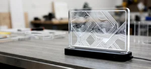 Laser-cut acrylic LED desk sign with flame-polished edges and frosted engraving