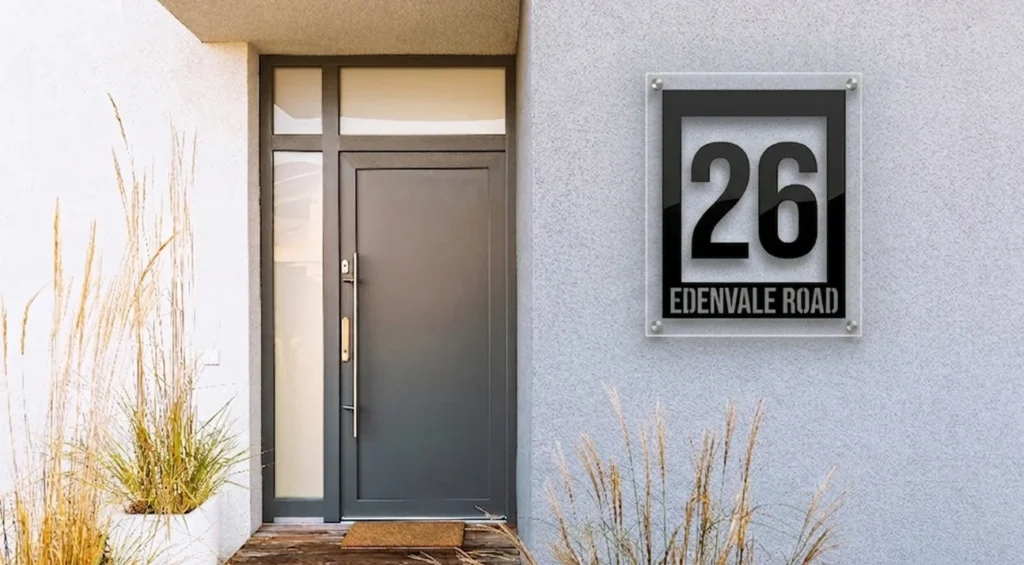 Modern acrylic house number sign displaying 26 Edenvale Road, mounted with standoffs on a contemporary home exterior