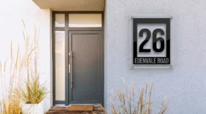 Modern acrylic house number sign displaying 26 Edenvale Road, mounted with standoffs on a contemporary home exterior