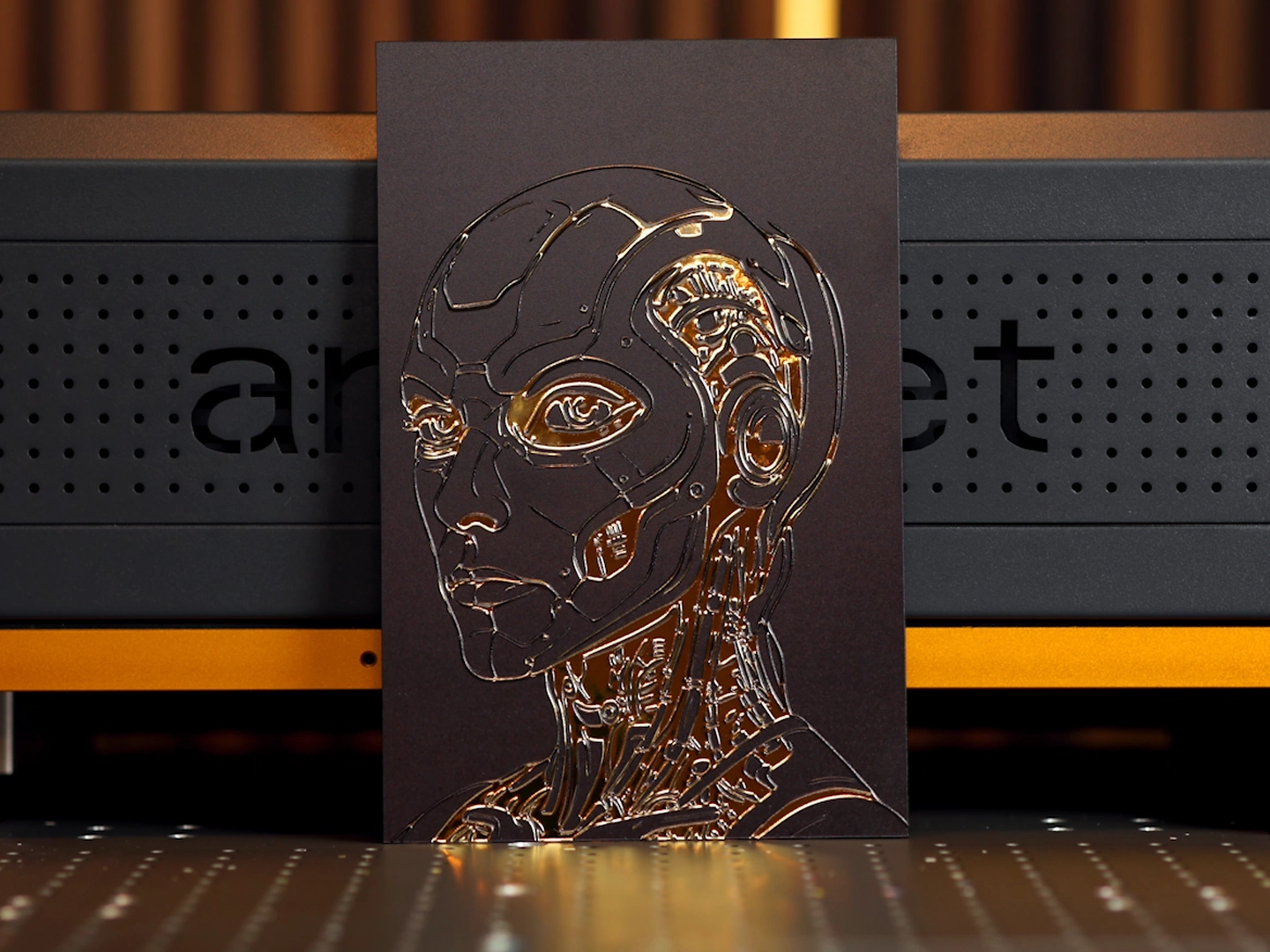 Gold mirror acrylic panel with a reflective robotic portrait and raised UV-printed detail.