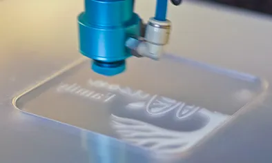 Laser engraving head marking a metal workpiece