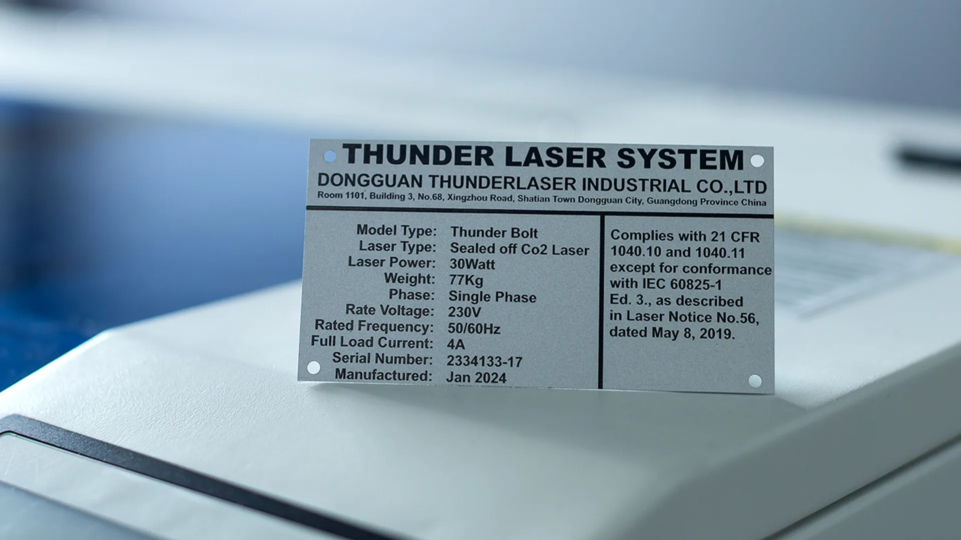 Engraved aluminium identification plate for a Thunder Bolt 30W CO₂ laser, displaying manufacturer details, electrical specifications, serial number, manufacture date, and compliance information.