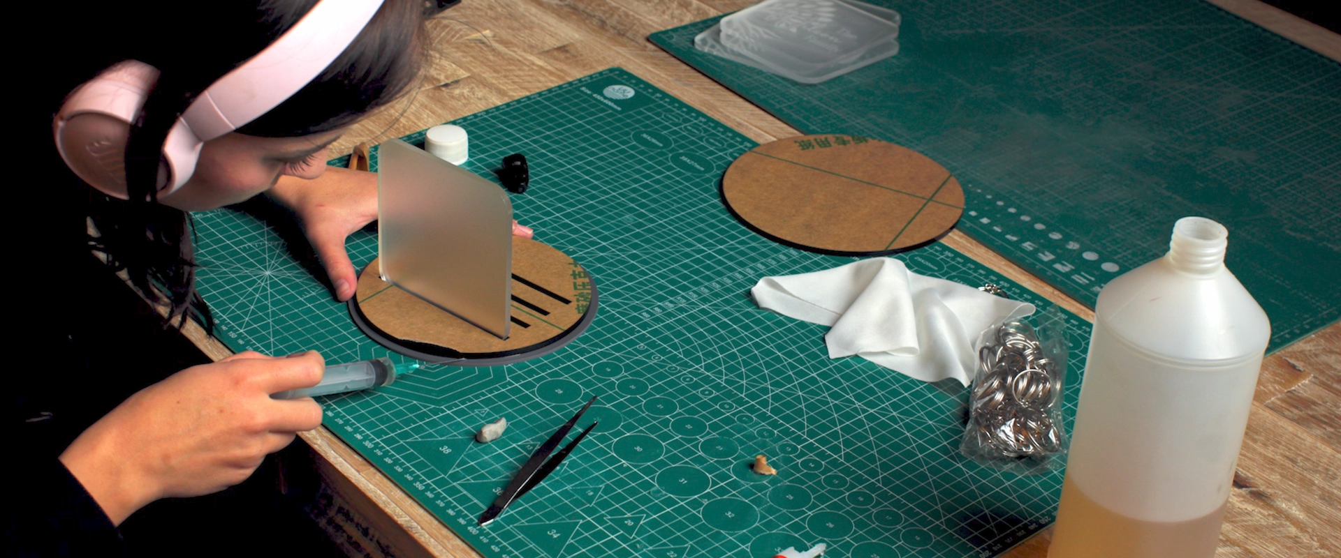 Assembling laser-cut acrylic gift pieces on a workbench after cutting and engraving