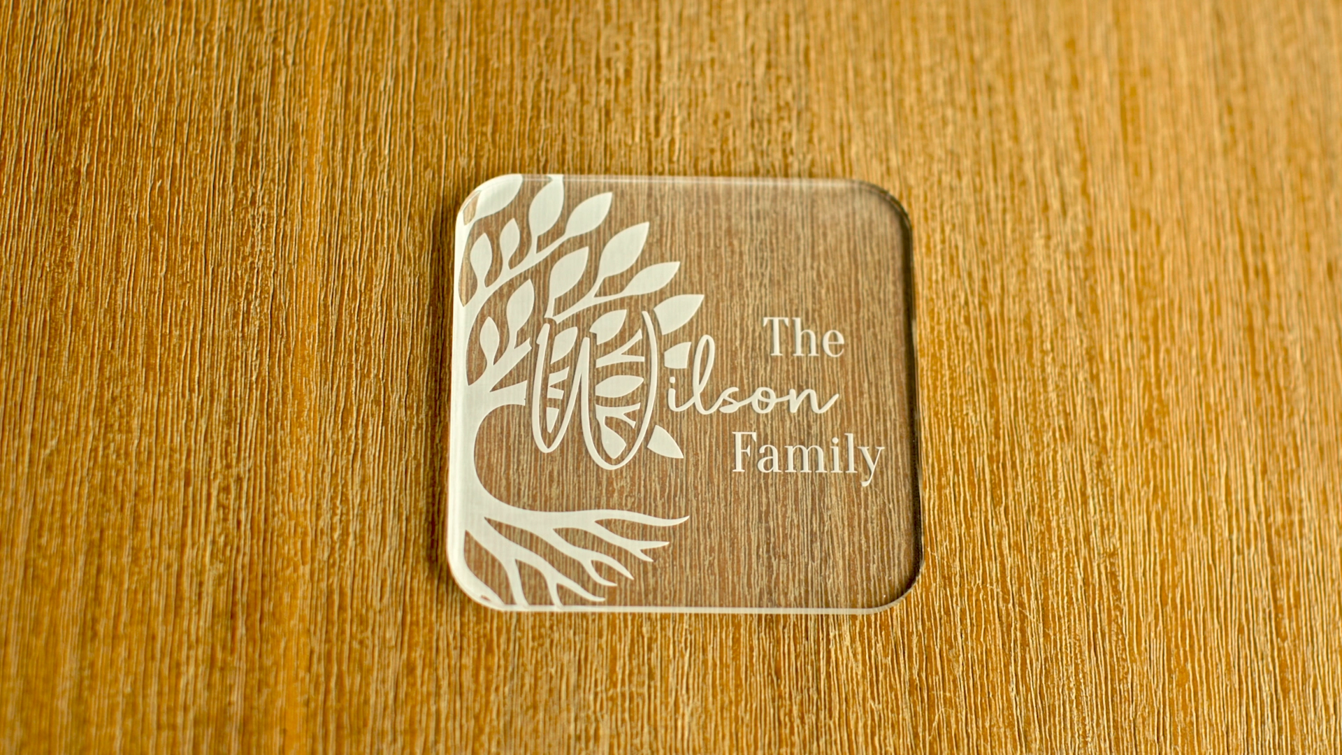 Personalised laser cut clear acrylic coaster engraved with a family tree design and Wilson family name