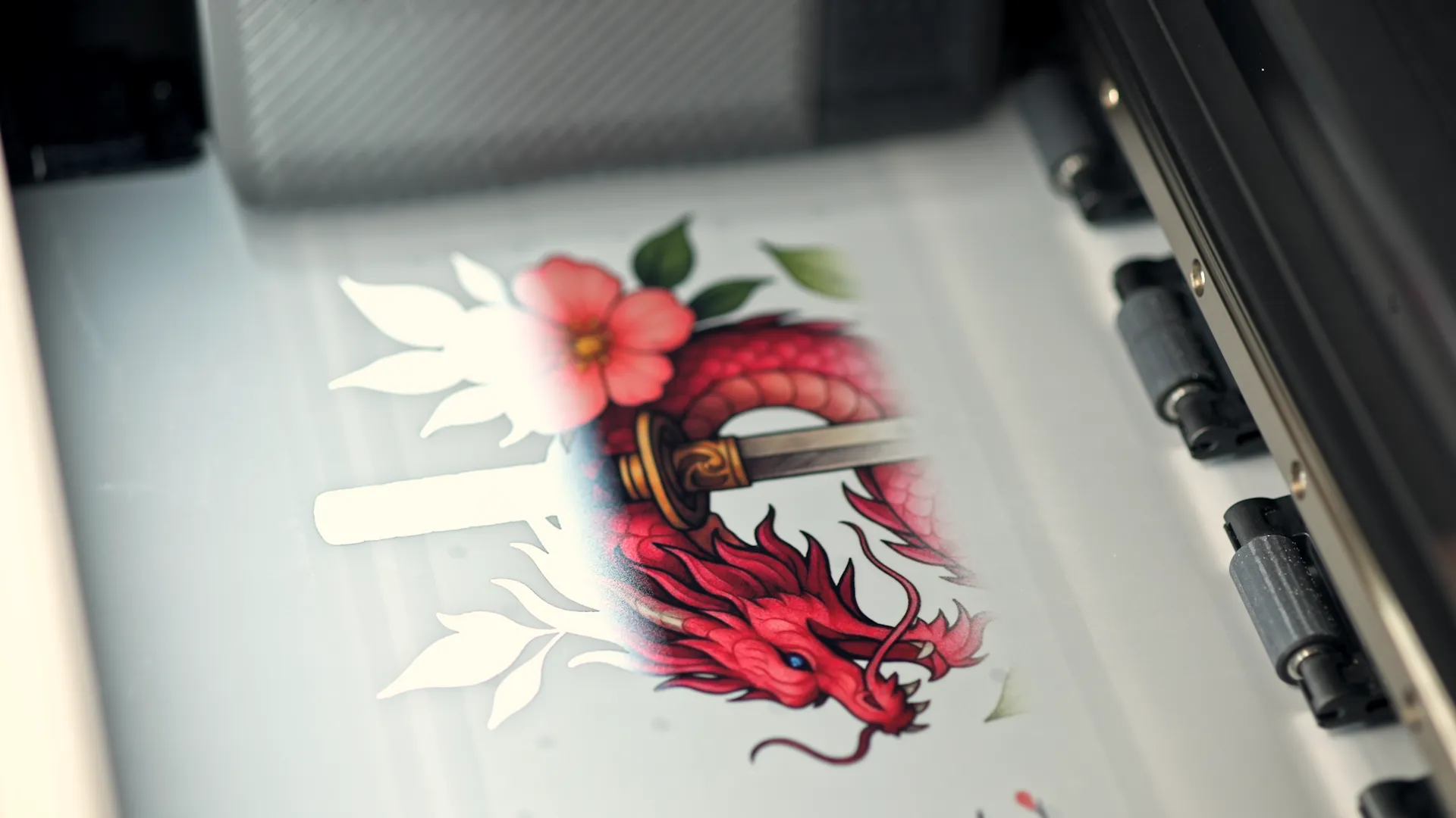 xTool Apparel Printer producing a red dragon DTF transfer on film