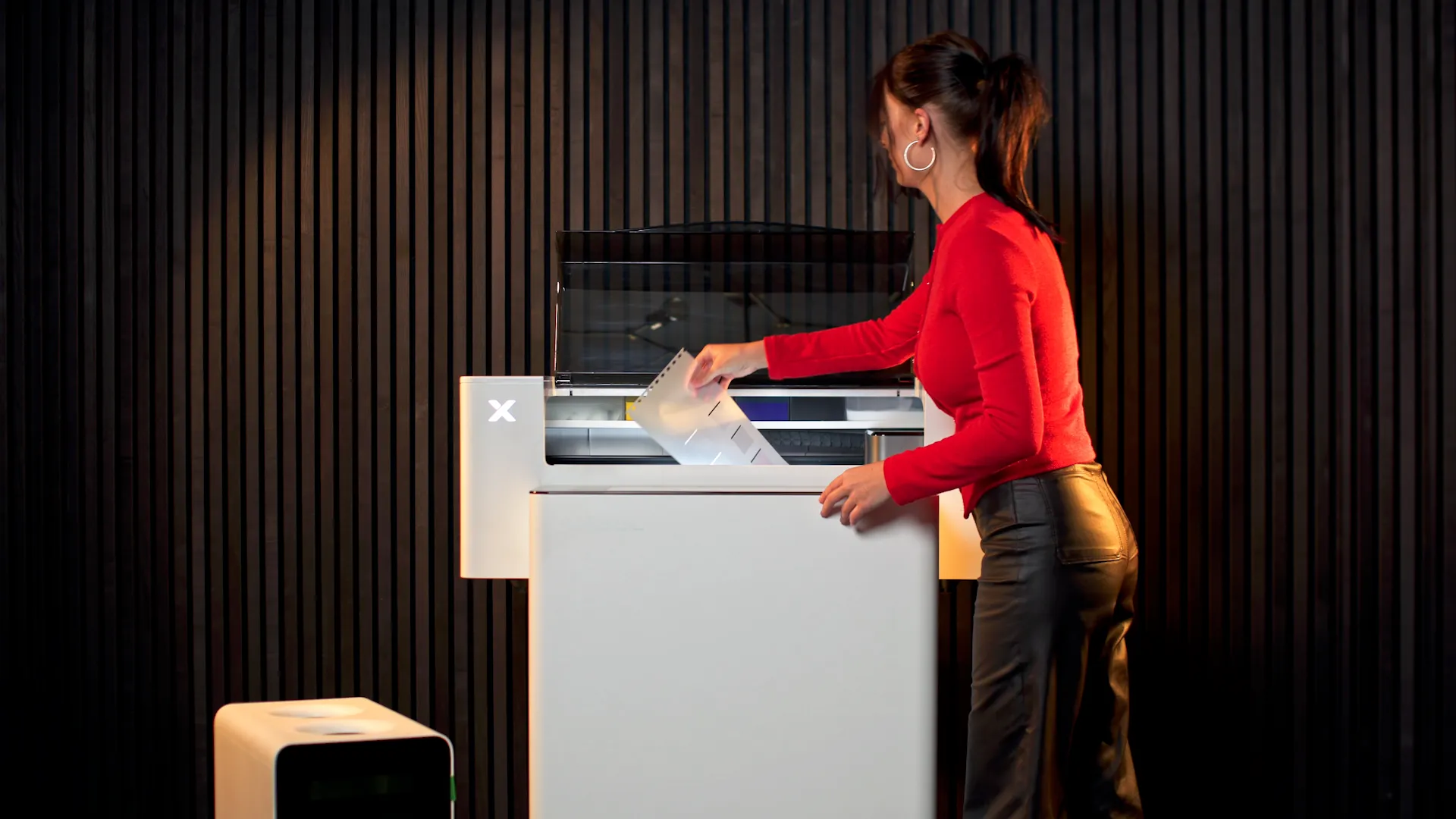User loading DTF film into xTool Apparel Printer