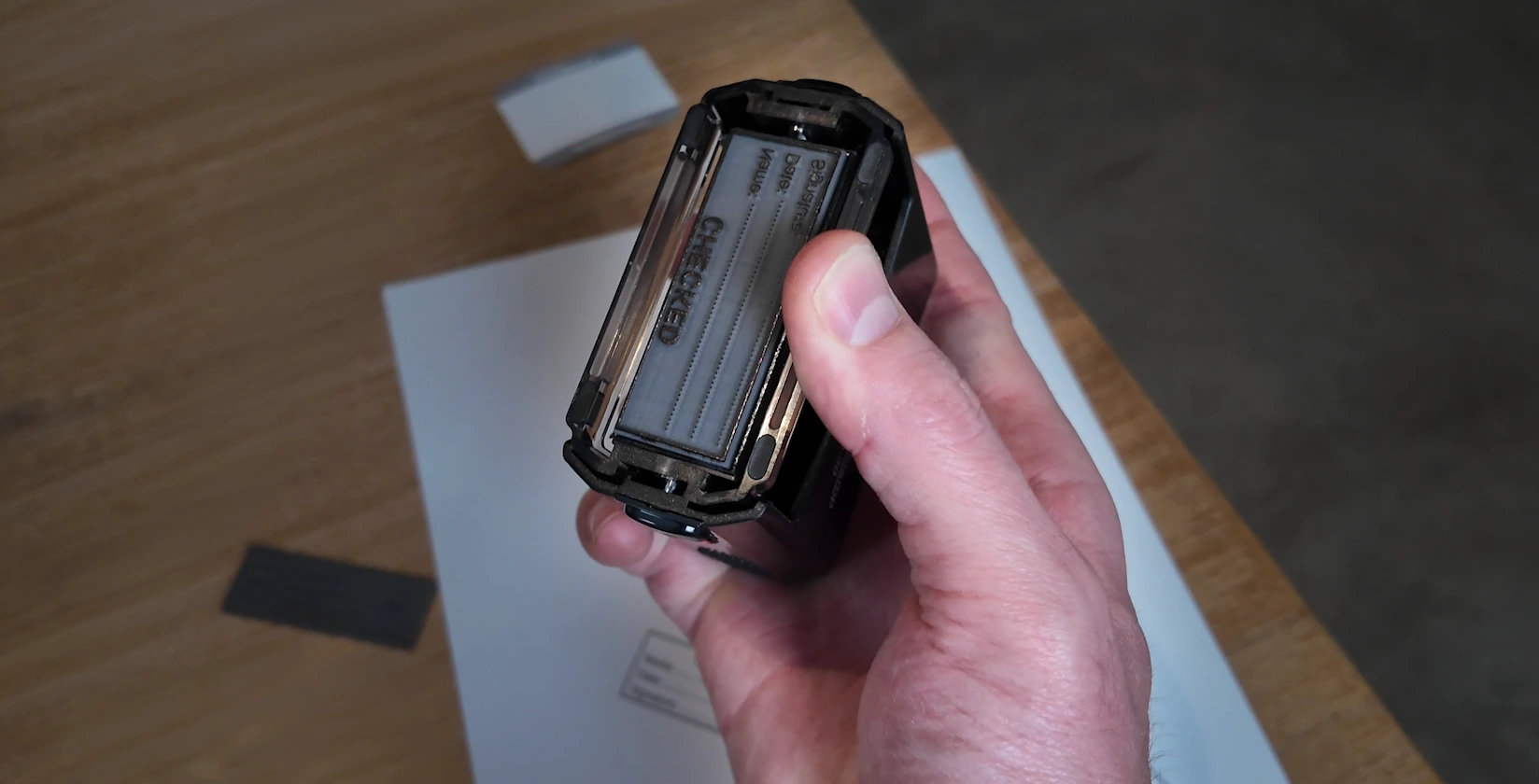 Laser engraved rubber stamp plate mounted in a self-inking stamp holder