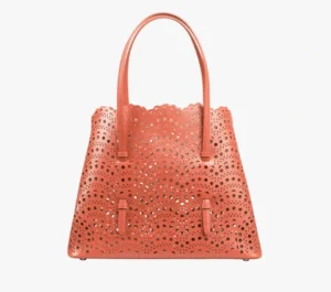 Leather handbag with an intricate cut-out pattern across the front and sides.