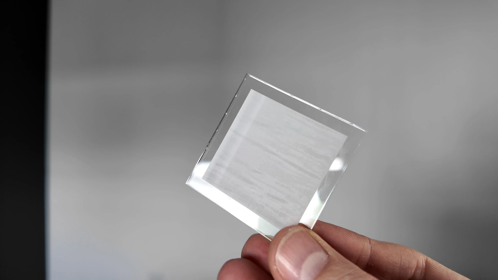 Clear acrylic test piece showing frosted engraving with visible horizontal scan lines