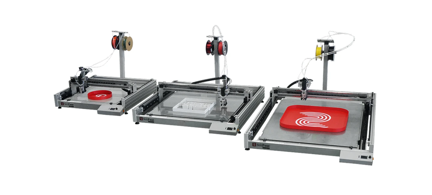 3D printers with filament spools, shown printing red and white objects on open print beds.