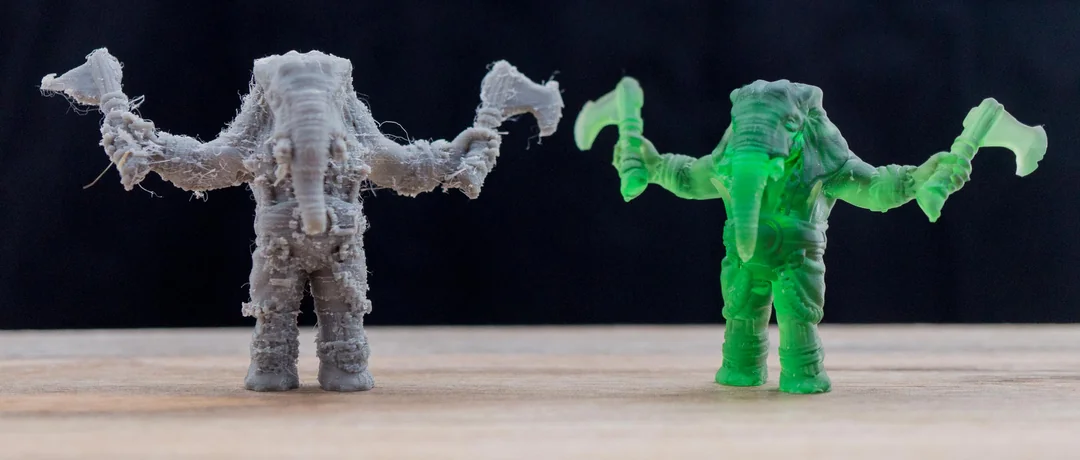 Two 3D printed models showing differences in surface finish and detail between FDM and resin 3D printing.