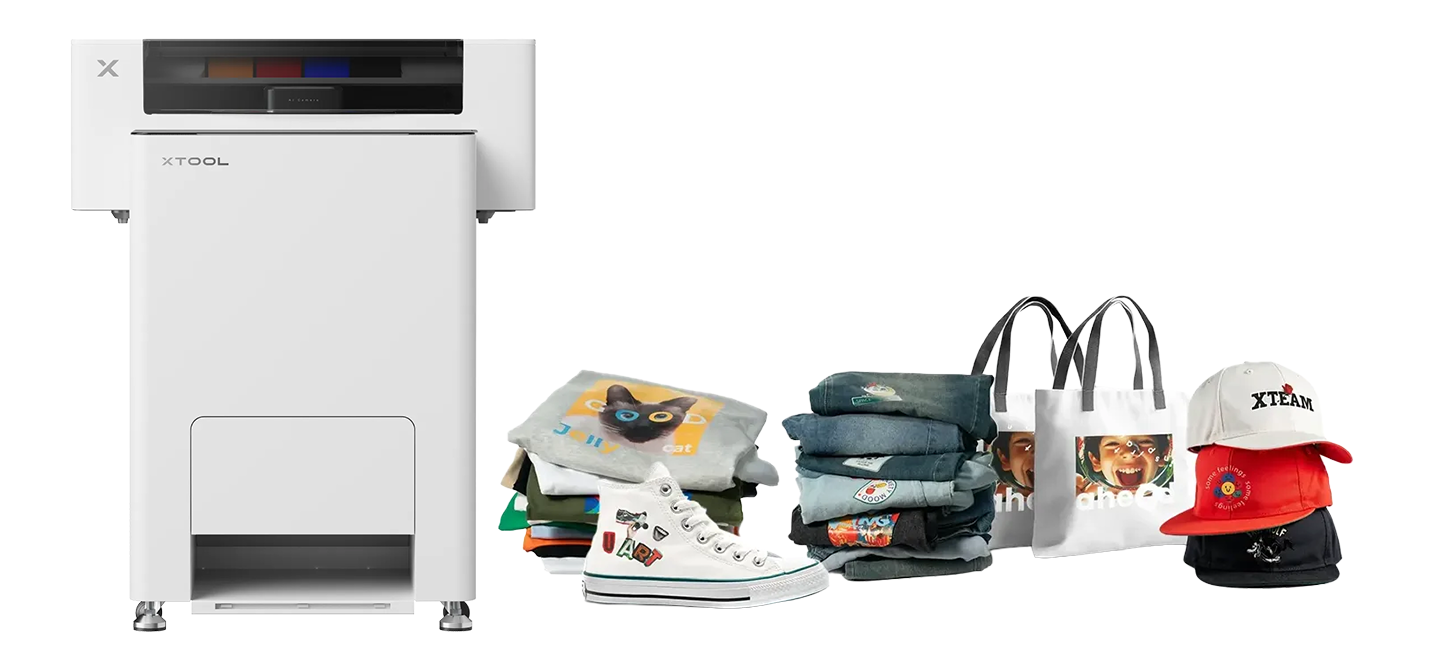 White xTool Apparel Printer compact DTF system with custom-printed T-shirts, tote bags, caps and a sneaker