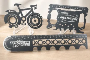 Laser-cut metal Thunder Laser multi-tools featuring rulers, gauges, bottle openers and measurement guides.